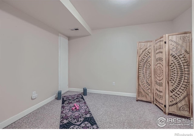 exercise area with baseboards, visible vents, and carpet flooring