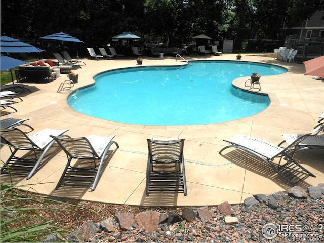 community pool featuring a patio area and fence