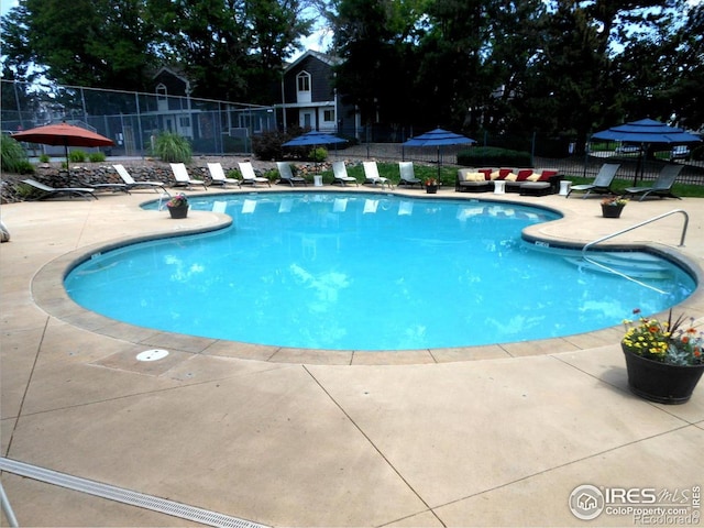 pool featuring a patio area and fence