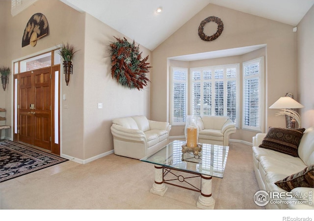 carpeted living area featuring high vaulted ceiling and baseboards