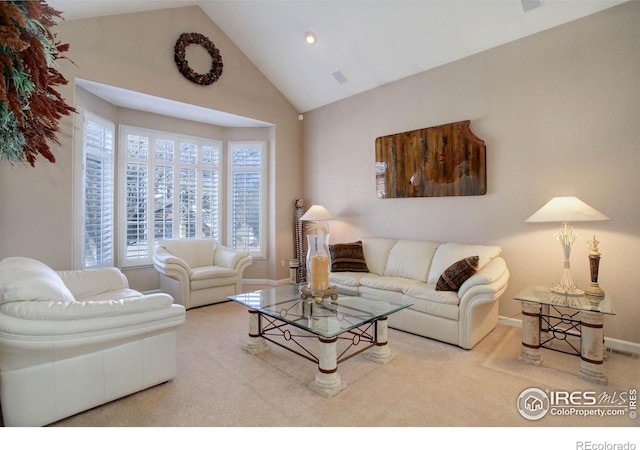 carpeted living area featuring high vaulted ceiling, visible vents, and baseboards