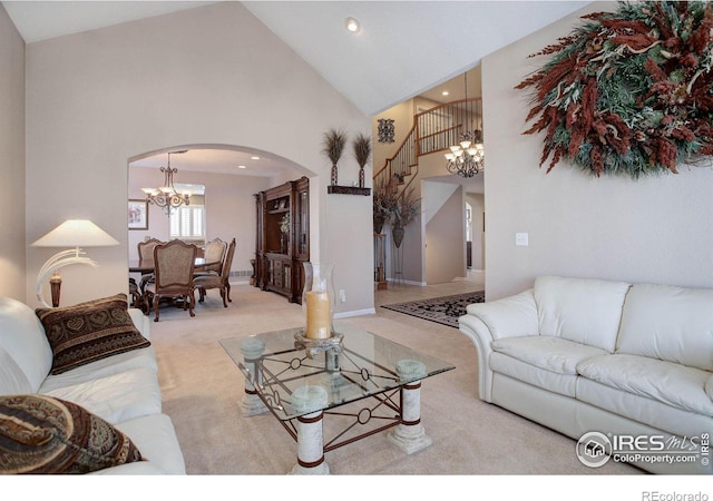 carpeted living area featuring arched walkways, stairway, high vaulted ceiling, a notable chandelier, and recessed lighting