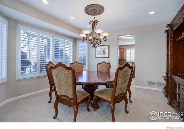 dining space featuring light carpet, baseboards, and visible vents