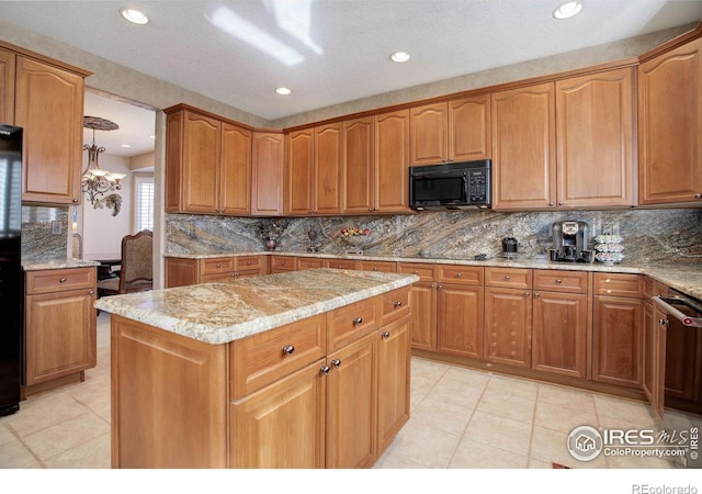 kitchen with black appliances, tasteful backsplash, a kitchen island, and light stone countertops