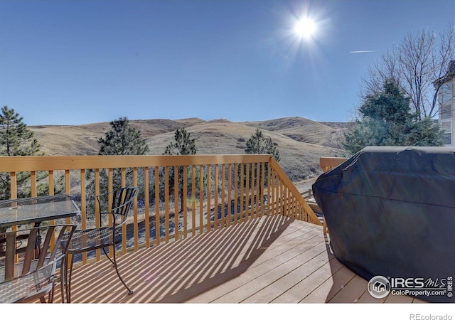 deck with a mountain view and area for grilling