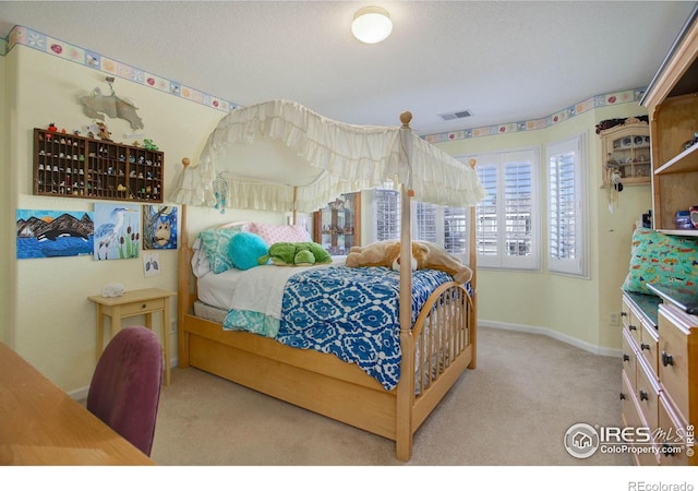 bedroom featuring carpet, a textured ceiling, visible vents, and baseboards