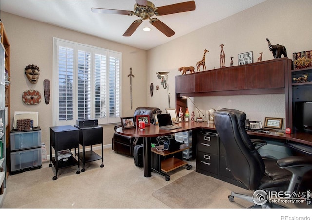 office area featuring ceiling fan, baseboards, and light colored carpet