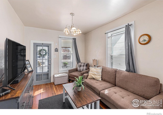 living area with an inviting chandelier and wood finished floors