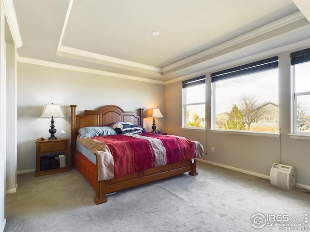 bedroom with a tray ceiling, crown molding, and light colored carpet