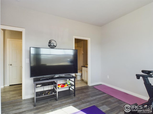 workout room with dark wood finished floors and baseboards