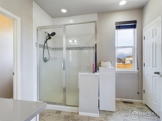 bathroom featuring a stall shower, recessed lighting, vanity, and baseboards