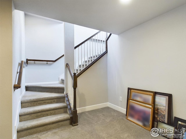 stairway featuring carpet flooring and baseboards