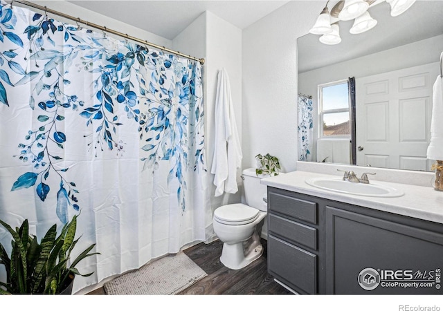 full bath with vanity, toilet, and wood finished floors