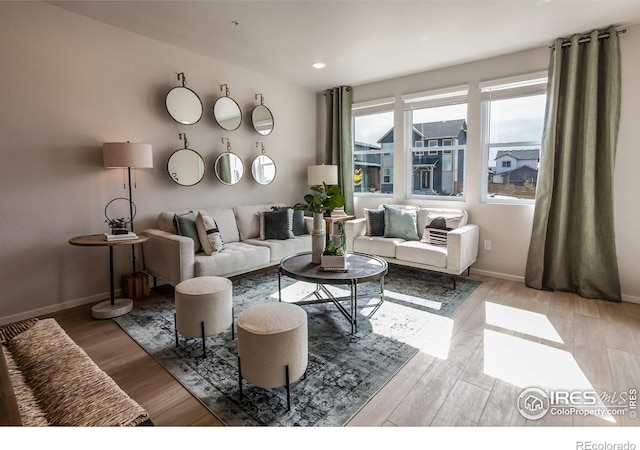 living room with recessed lighting, wood finished floors, and baseboards