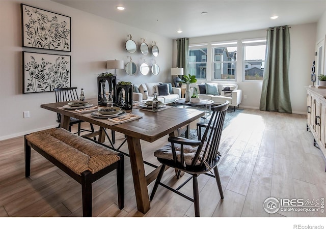 dining space featuring recessed lighting, baseboards, and light wood finished floors