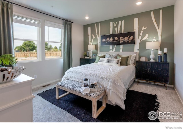 carpeted bedroom with recessed lighting, visible vents, and baseboards