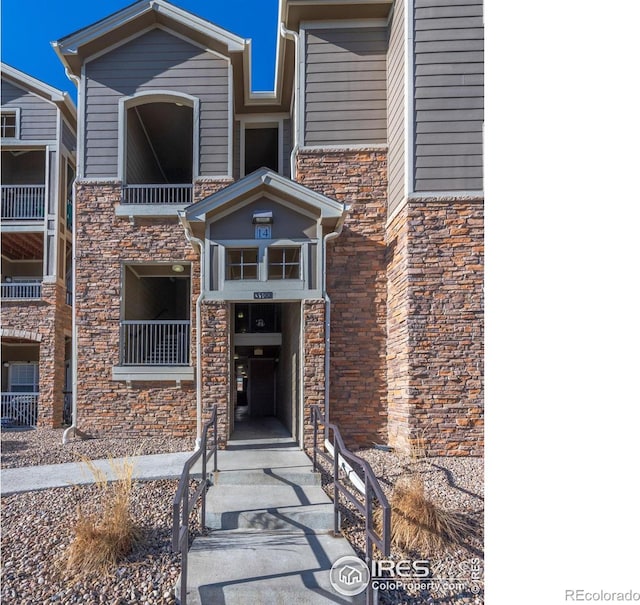 view of exterior entry featuring stone siding