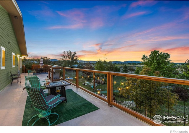 view of patio / terrace with an outdoor fire pit and a mountain view