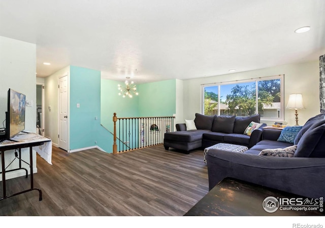 living room featuring baseboards, dark wood finished floors, a notable chandelier, and recessed lighting