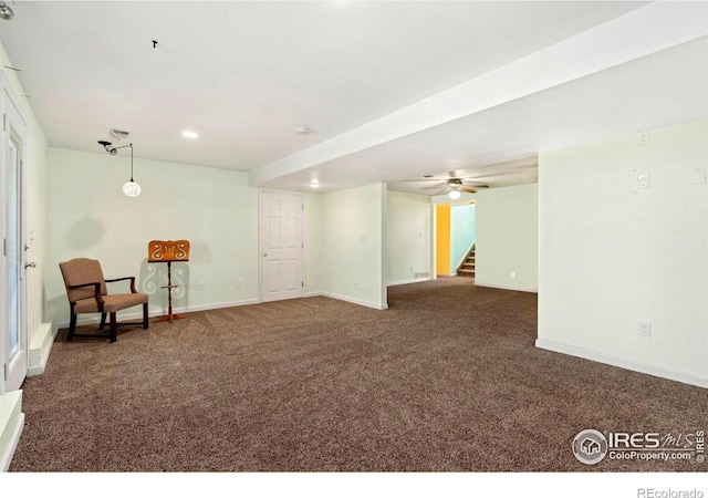 sitting room featuring stairs, recessed lighting, dark carpet, and baseboards