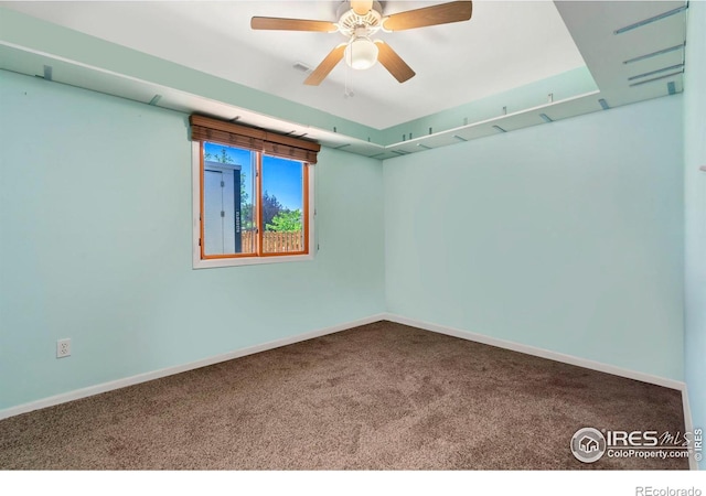 carpeted empty room with a ceiling fan, visible vents, and baseboards