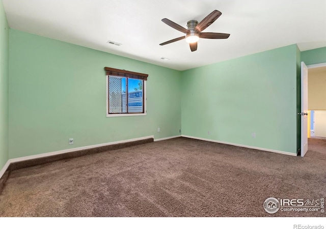 spare room with baseboards, visible vents, ceiling fan, and carpet flooring