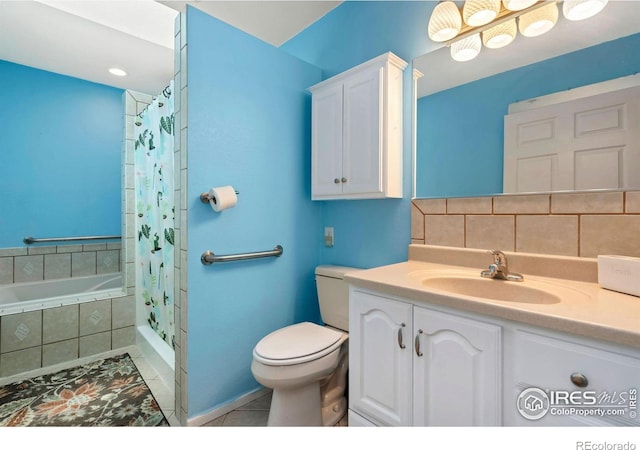 bathroom with tile patterned flooring, toilet, vanity, tiled shower, and tasteful backsplash