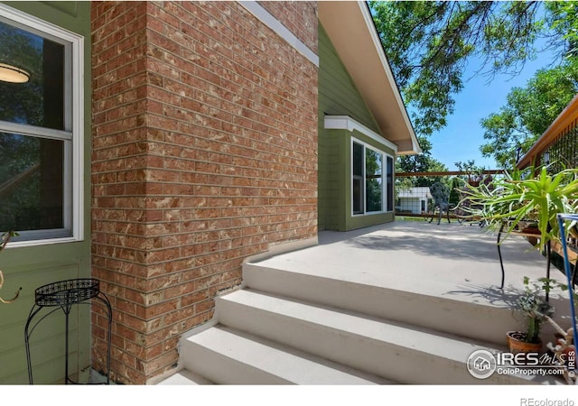 exterior space featuring brick siding