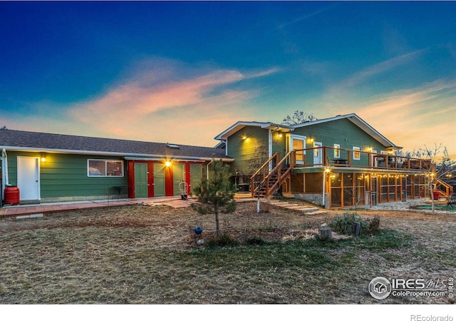 view of front of property featuring stairs and a wooden deck