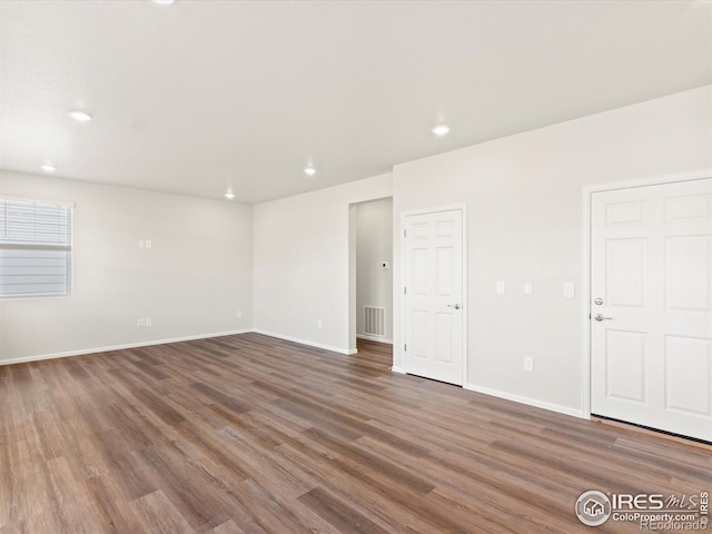 unfurnished room featuring recessed lighting, visible vents, baseboards, and wood finished floors