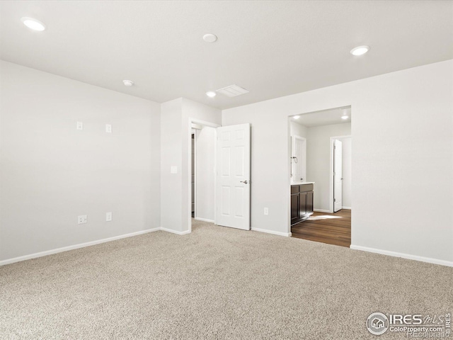 unfurnished room featuring recessed lighting, carpet, and baseboards