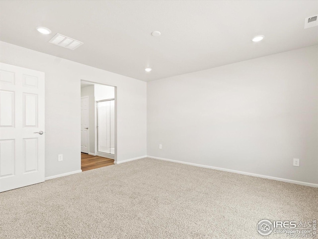 spare room featuring baseboards, visible vents, carpet flooring, and recessed lighting