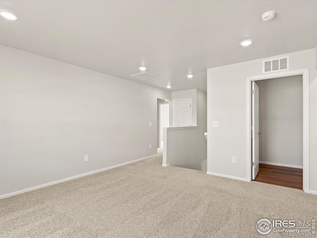 unfurnished bedroom with carpet floors, recessed lighting, visible vents, and baseboards