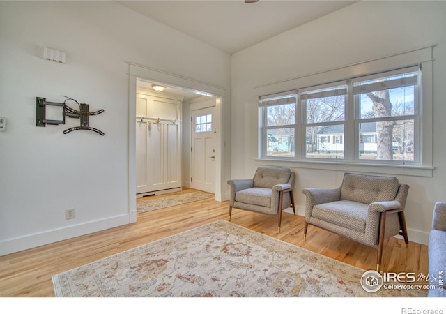 sitting room featuring baseboards and wood finished floors