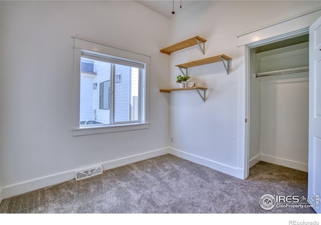 unfurnished bedroom with carpet, a closet, visible vents, and baseboards