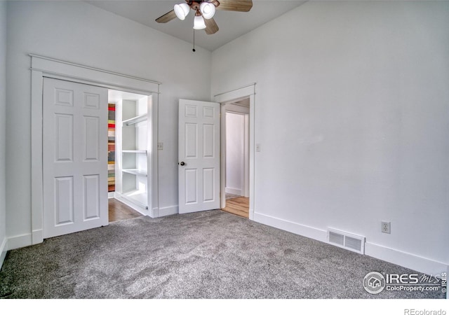 unfurnished bedroom with carpet floors, baseboards, visible vents, and a ceiling fan