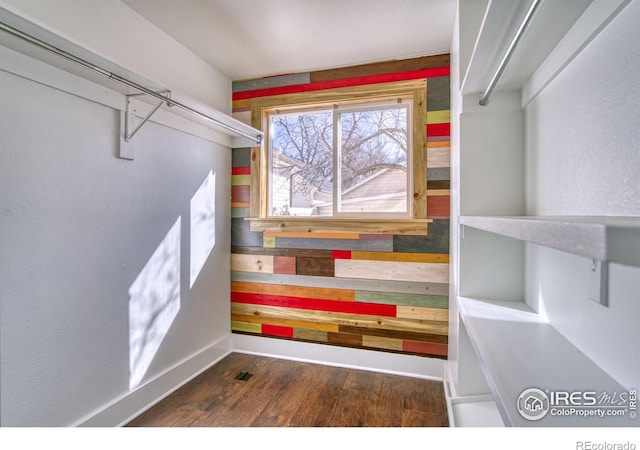 spacious closet featuring wood finished floors