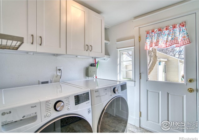 laundry room with cabinet space and washer and clothes dryer