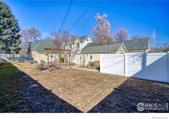 view of yard featuring fence and a patio