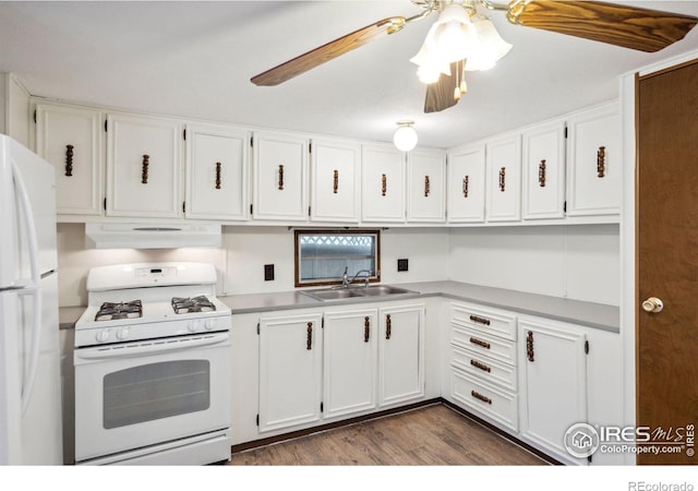 kitchen with under cabinet range hood, white appliances, a sink, white cabinets, and light countertops