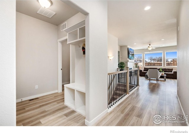 mudroom with wood finished floors and visible vents