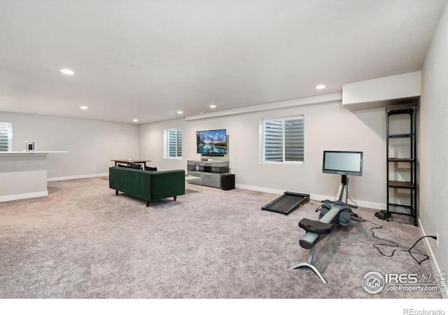 carpeted living room with recessed lighting and baseboards