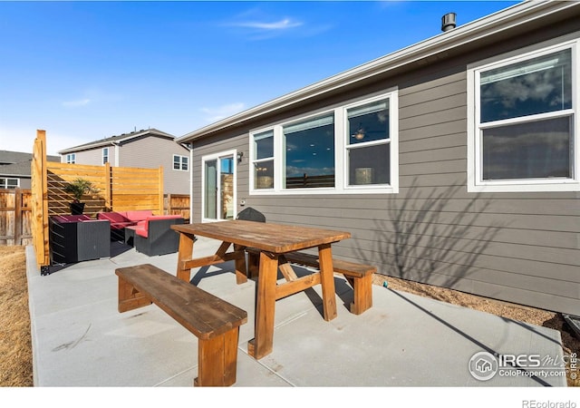 view of patio / terrace featuring outdoor dining space, fence, and an outdoor hangout area