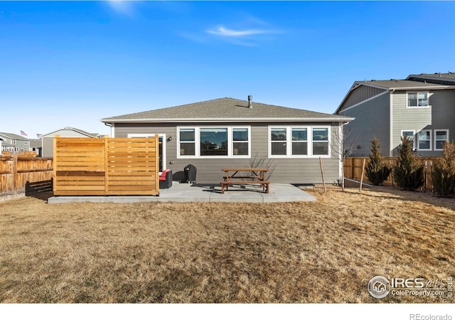 back of house with a lawn, a patio area, and a fenced backyard