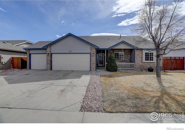 single story home with brick siding, fence, driveway, and an attached garage