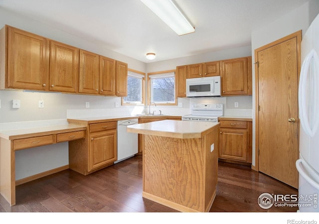 kitchen featuring light countertops, white appliances, dark wood-type flooring, and a kitchen island