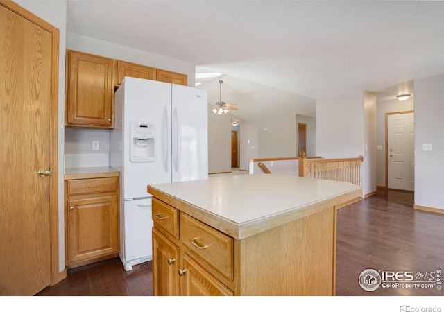 kitchen with dark wood-style floors, light countertops, a kitchen island, ceiling fan, and white fridge with ice dispenser