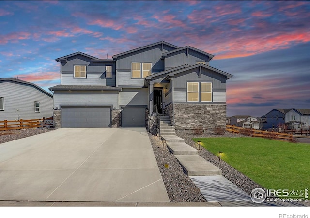 55 Morgan Cir S, Erie, CO 80516 - view of front facade with stone siding, a garage, and driveway