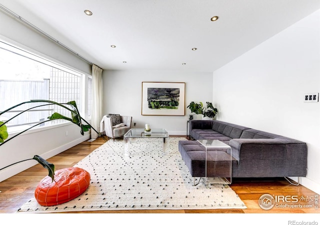 living room with recessed lighting, wood finished floors, and baseboards