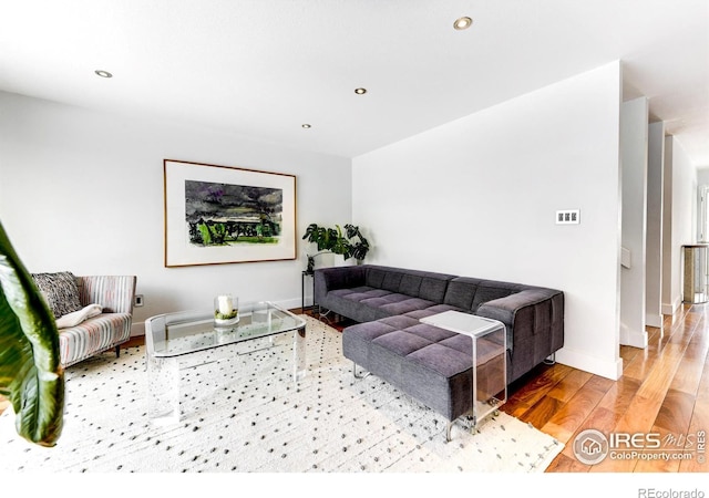 living area featuring recessed lighting, baseboards, and wood finished floors